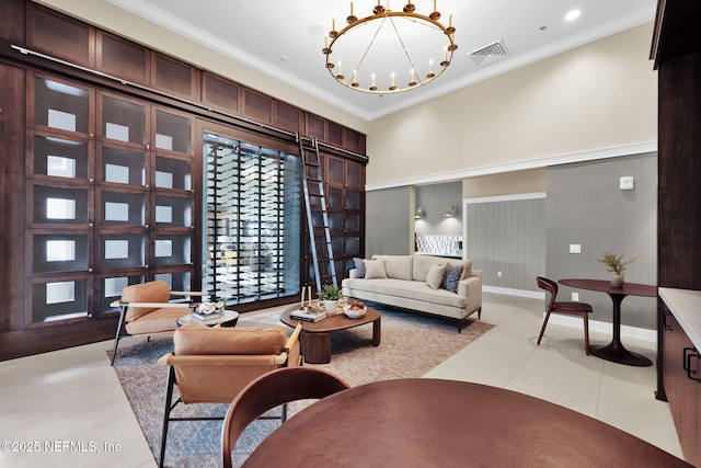 living room with crown molding, a chandelier, light tile patterned floors, visible vents, and a towering ceiling