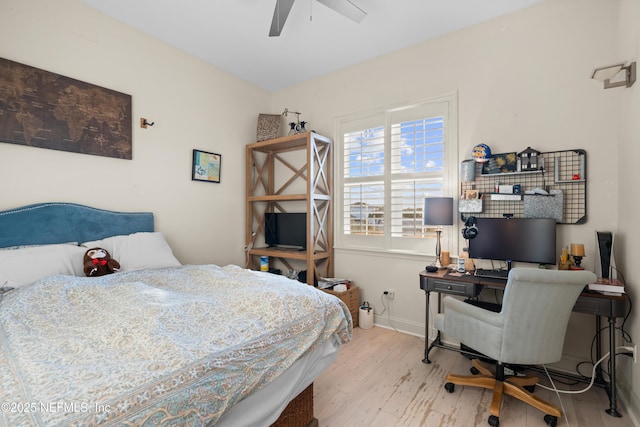 bedroom featuring a ceiling fan, baseboards, and light wood finished floors