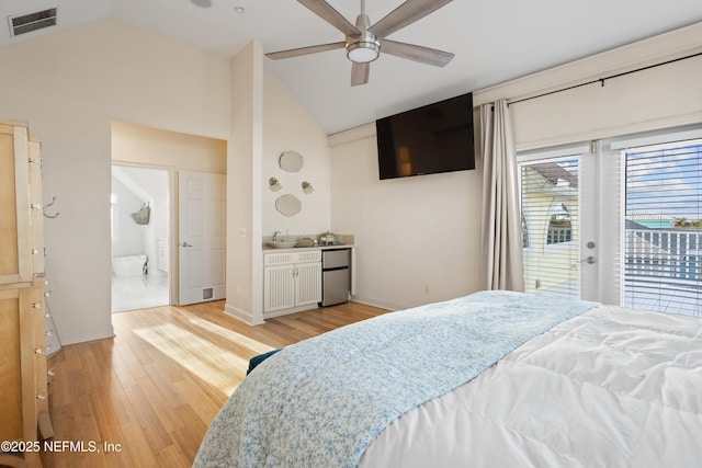 bedroom with light wood-style flooring, visible vents, access to exterior, vaulted ceiling, and fridge