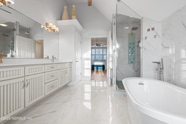 bathroom with marble finish floor, a marble finish shower, vanity, high vaulted ceiling, and a freestanding tub