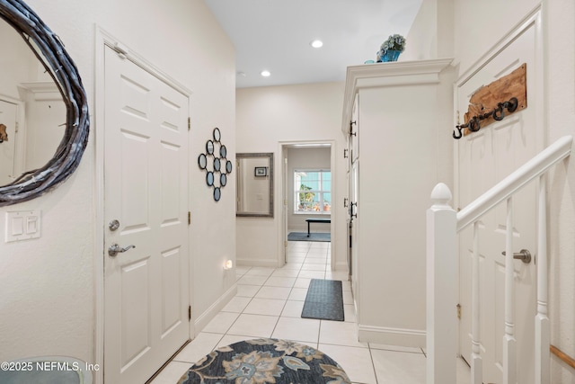 entrance foyer with recessed lighting, baseboards, and light tile patterned floors