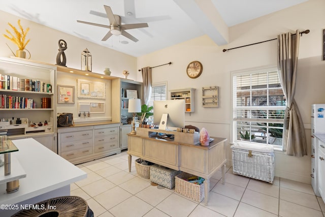 office space featuring a ceiling fan, beamed ceiling, and light tile patterned flooring