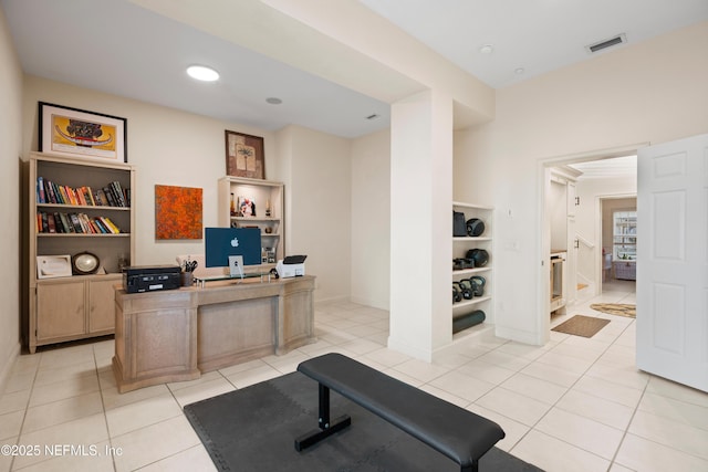 home office with built in shelves, visible vents, and light tile patterned floors