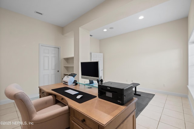 office area with light tile patterned flooring, visible vents, and baseboards