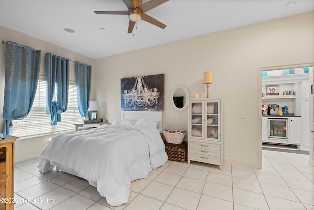 bedroom featuring wine cooler, ceiling fan, baseboards, and light tile patterned floors