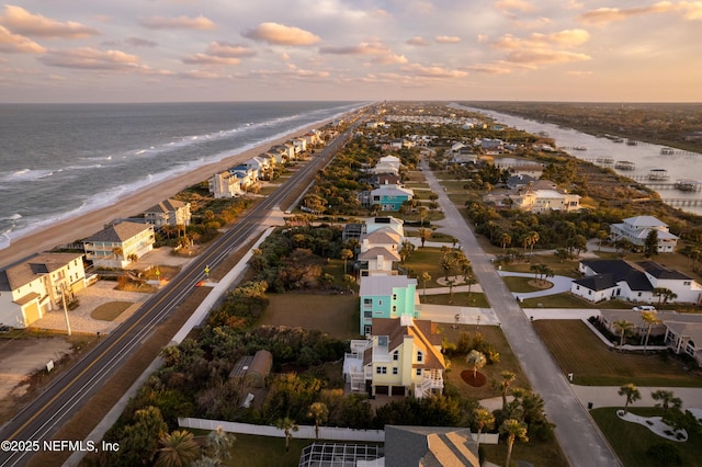 bird's eye view with a view of the beach, a water view, and a residential view