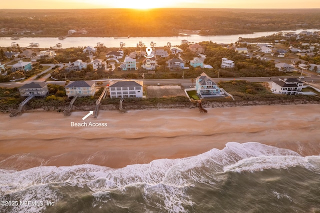 drone / aerial view with a water view and a residential view