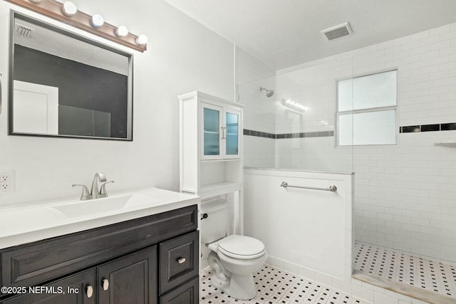 full bath featuring toilet, visible vents, walk in shower, and vanity