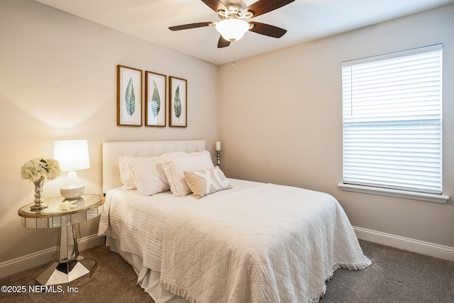 bedroom with baseboards, dark colored carpet, and a ceiling fan