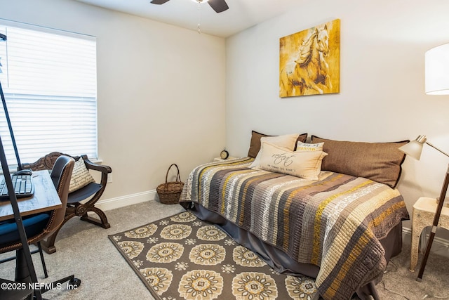 carpeted bedroom with ceiling fan and baseboards