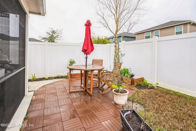 view of patio featuring outdoor dining area and a fenced backyard