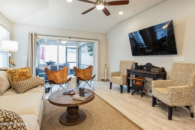 living room featuring vaulted ceiling, ceiling fan, light wood-style flooring, and recessed lighting