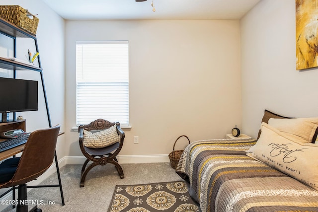 bedroom featuring light carpet and baseboards