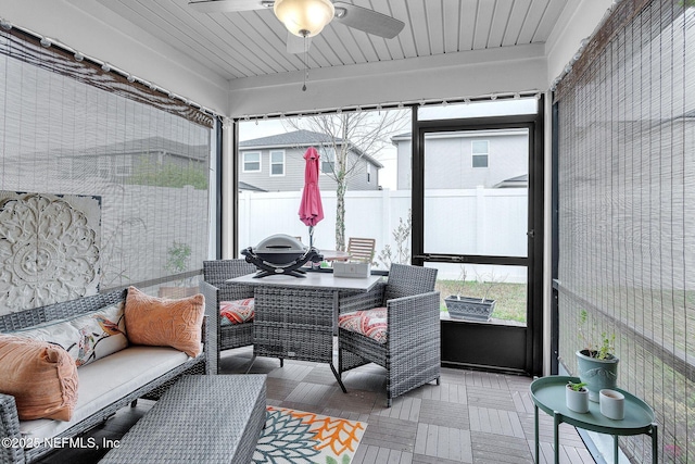 sunroom / solarium with a ceiling fan