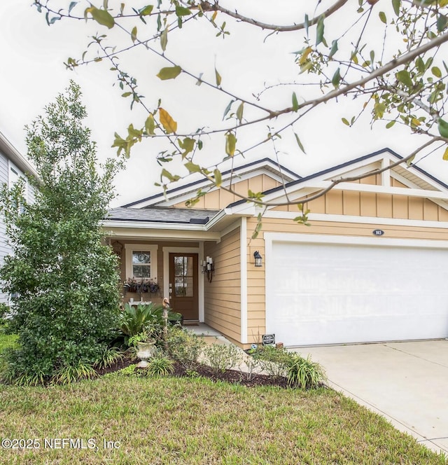 view of front of home featuring an attached garage, driveway, and board and batten siding