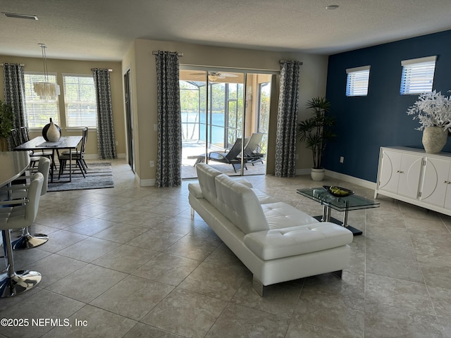 503 Mangrove Thicket Blvd, Ponte Vedra, FL 32081 - living room featuring baseboards, a textured ceiling, and plenty of natural light