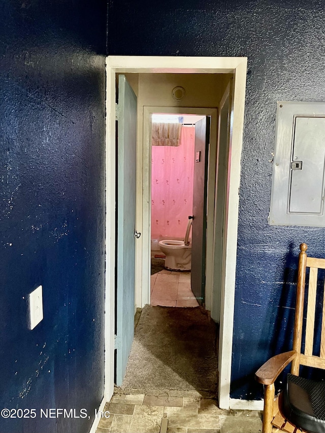 hallway with light tile patterned floors, electric panel, and light colored carpet