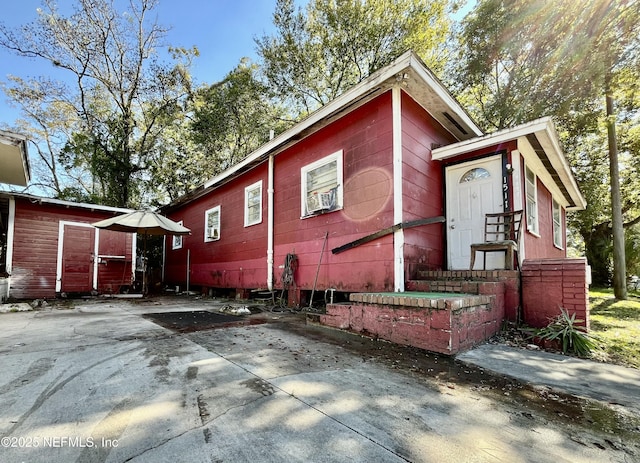 view of home's exterior featuring concrete driveway