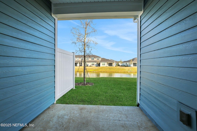 view of yard featuring a residential view and a water view