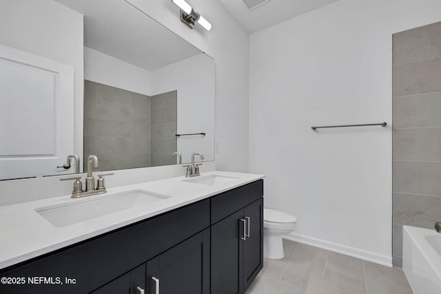 bathroom featuring baseboards, a sink, toilet, and double vanity