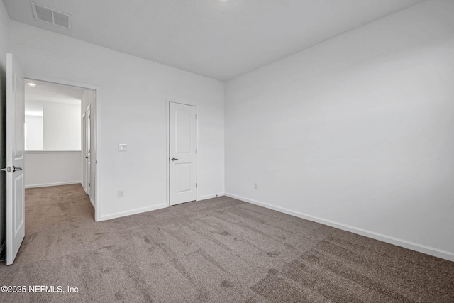 unfurnished bedroom featuring carpet floors, visible vents, and baseboards