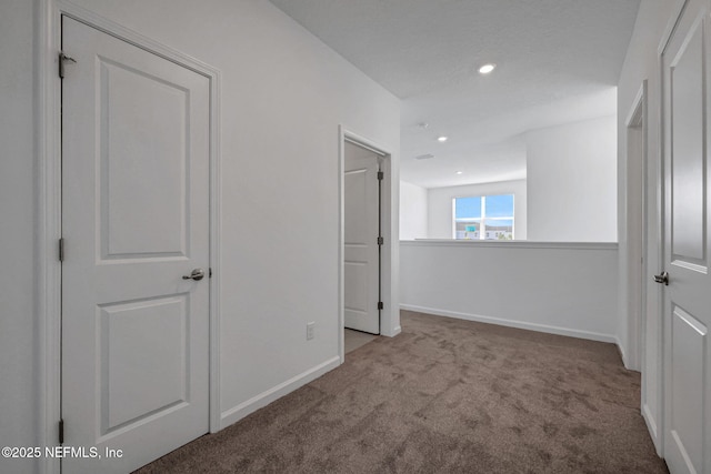 unfurnished bedroom featuring light carpet, recessed lighting, and baseboards