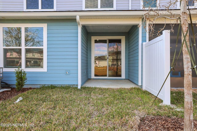 entrance to property featuring a lawn