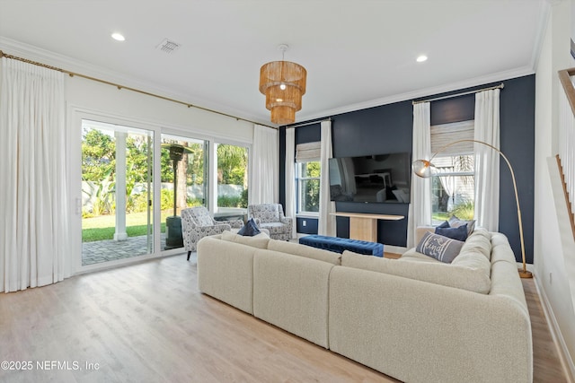 living room featuring ornamental molding, recessed lighting, visible vents, and wood finished floors