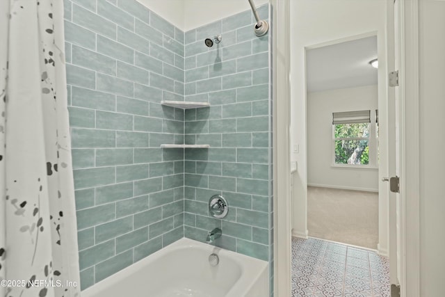 bathroom featuring tub / shower combination and baseboards