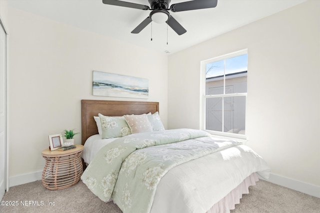 bedroom with light carpet, ceiling fan, and baseboards