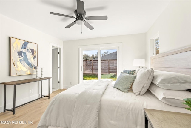 bedroom with access to exterior, light wood-style flooring, baseboards, and a ceiling fan