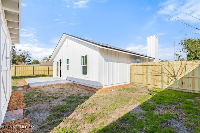 back of property featuring a patio area and a fenced backyard