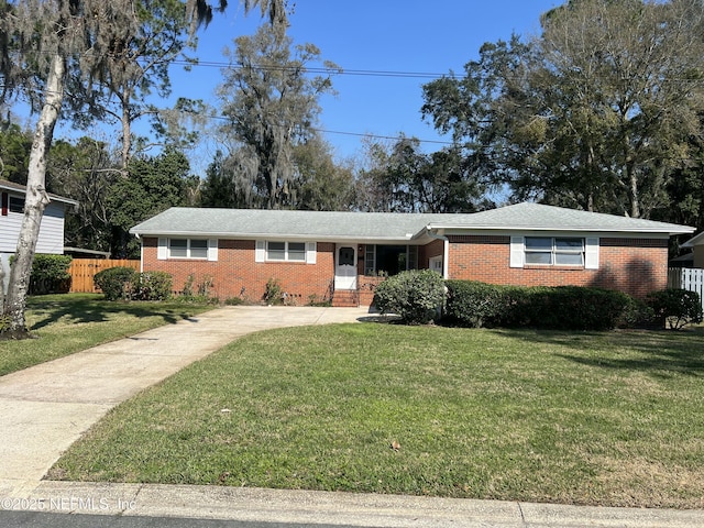 ranch-style home with a front lawn, fence, and brick siding