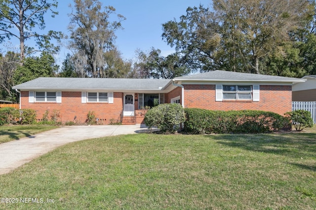 ranch-style home featuring entry steps, a garage, a front yard, and brick siding