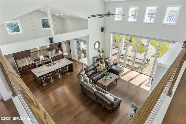 living area with ceiling fan, high vaulted ceiling, dark wood finished floors, and recessed lighting