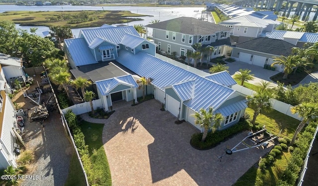 drone / aerial view featuring a residential view and a water view