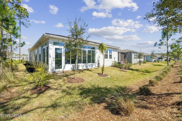 427 Ladyslipper Dr, Saint Johns, FL 32259 - back of house with a sunroom and a yard