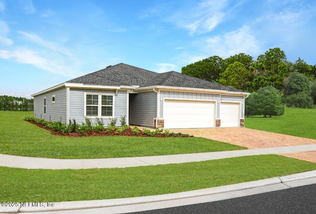 2991 Granary Park Ave, Green Cove Springs, FL 32043 - view of front of property featuring decorative driveway, a garage, a front yard, and roof with shingles