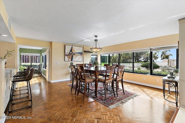 dining area with a textured ceiling and baseboards