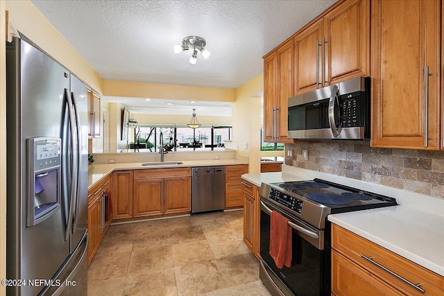 kitchen with brown cabinetry, tasteful backsplash, stainless steel appliances, and light countertops