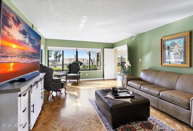 living area featuring baseboards and a textured ceiling