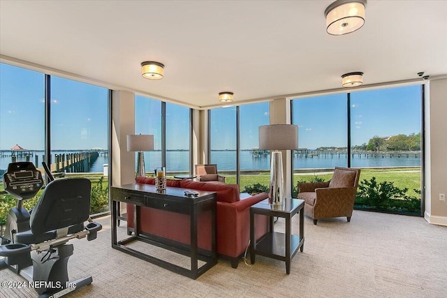 sunroom / solarium featuring a water view