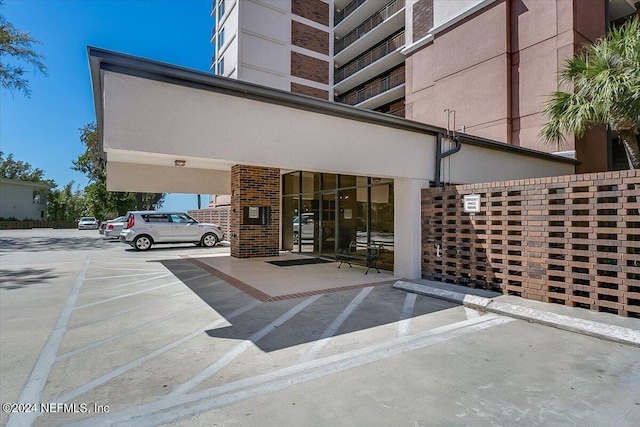 property entrance with brick siding and stucco siding