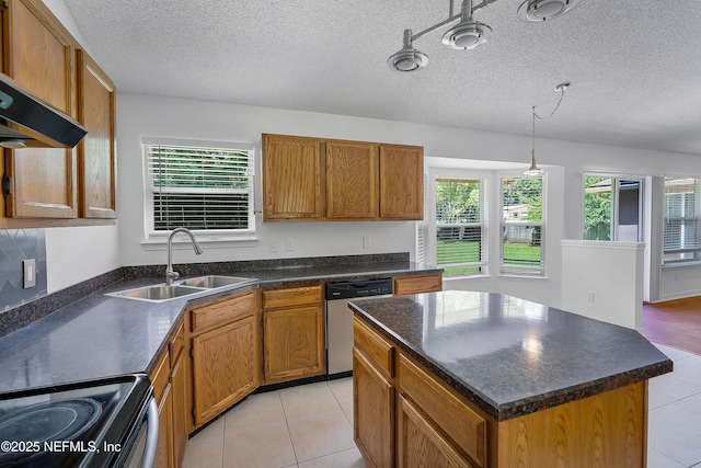 kitchen featuring appliances with stainless steel finishes, dark countertops, and a kitchen island