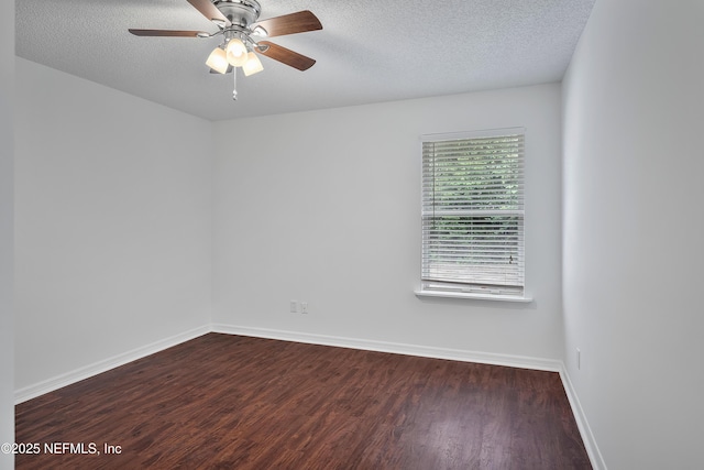 spare room with a ceiling fan, dark wood-style flooring, a textured ceiling, and baseboards