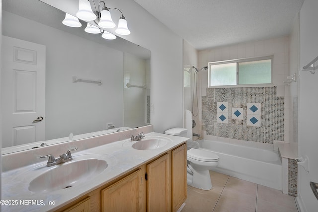 bathroom with a textured ceiling, a sink, washtub / shower combination, and tile patterned floors