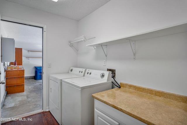 laundry area featuring laundry area, separate washer and dryer, and a textured ceiling