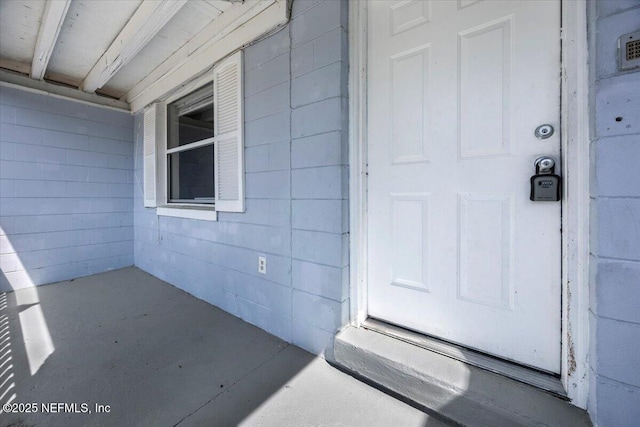 view of exterior entry with concrete block siding