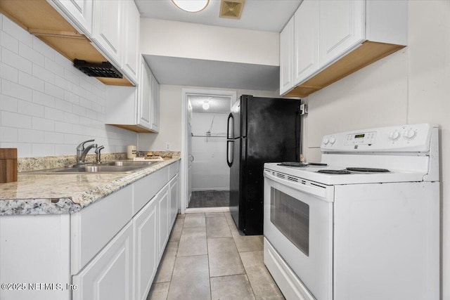 kitchen featuring electric stove, light countertops, visible vents, decorative backsplash, and a sink