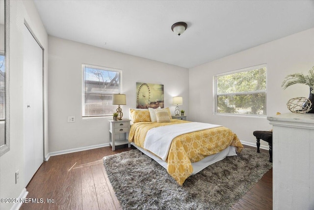 bedroom with hardwood / wood-style floors and baseboards